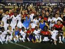Canadian players and staff celebrate qualifying for Qatar 2022 and winning the Conca Cafe after the match between Panama and Canada at Lommel Fernandez Stadium in Panama City, Panama on March 30, 2022. 