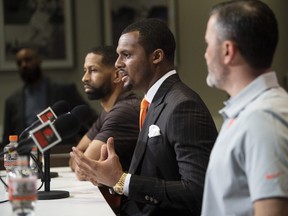 Cleveland Browns quarterback Deshaun Watson (centre)talk with the media during a news conference.
