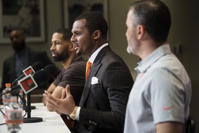Cleveland Browns quarterback Deshaun Watson (centre)talk with the media during a news conference.
