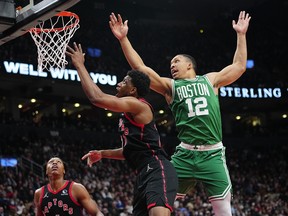 Toronto Raptors forward Thaddeus Young looks for a rebound against the Boston Celtics.