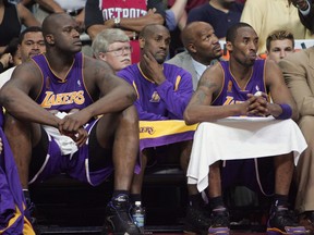 Shaquille O'Neal, Left, Gary Payton, Central, Los Angeles Lakers' Kobe Bryant is watching from the bench in the fourth quarter of the fifth game of the 2004 NBA Finals against the Palace of Detroit Pistons on June 15, 2004. Auburn Hills in Auburn Hills, Michigan.