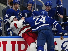 Feb 7, 2022; Toronto, Ontario, CAN; Toronto Maple Leafs forward Wayne Simmonds (24) fights with Carolina Hurricanes defenceman Brendan Smith (7) during the first period at Scotiabank Arena.