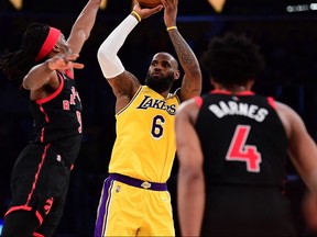 Los Angeles Lakers forward LeBron James (6) shoots against Toronto Raptors forward Precious Achiuwa (5) during the second half at Crypto.com Arena.