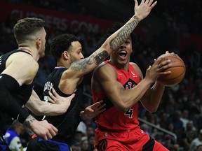 Raptors forward Scottie Barnes (4) moves the ball against Los Angeles Clippers guard Amir Coffey (7) and center Isaiah Hartenstein (55) during the second half at Crypto.com Arena on Wednesday night.