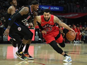 Raptors guard Fred VanVleet (23) moves to the basket against Los Angeles Clippers forward Robert Covington (23) on Wednesday.