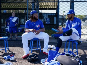 Blue Jays first baseman Vladimir Guerrero Jr. (27) and outfielder Teoscar Hernández (37) wait for batting practice to begin during workouts at Toronto Blue Jays Player Development Complex.