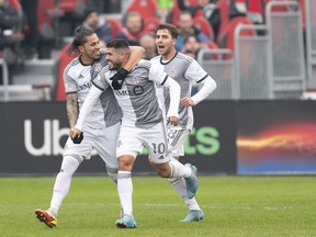 Toronto FC midfielder Alejandro Pozuelo (10) celebrates scoring a goal with Toronto FC defender Carlos Salcedo (3) during the first half against D.C. United at BMO Field on Saturday.