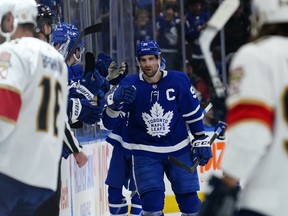 Maple Leafs' John Tavares is congratulated after scoring during the second period against the Florida Panthers at Scotiabank Arena on Sunday, March 27, 2022.