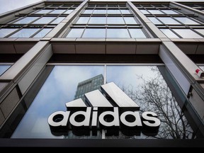 In this file photo taken on March 29, 2020 the logo of German sporting goods company Adidas is pictured at one of the company's outlets in Berlin on March 29, 2020.