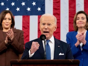 U.S. President Joe Biden gestures, applauded by Vice President Kamala Harris (L) and House Speaker Nancy Pelosi (D-CA), as he delivers his first State of the Union address at the U.S. Capitol in Washington, DC, on March 1, 2022.