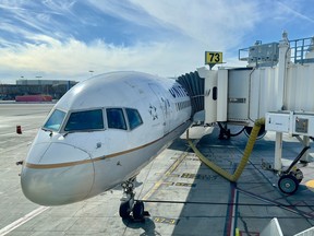 A United Airlines plane sits at a jetbridge