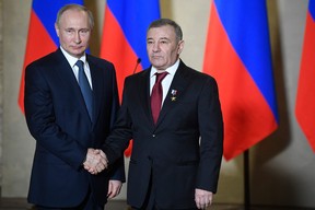 In this file photo taken on March 18, 2020, Russian President Vladimir Putin decorates businessman Arkady Rotenberg with the Hero of Labour medal during an awards ceremony for those who led the construction of the 19 km road and rail Crimean Bridge over the Kerch Strait – that links mainland Russia to Moscow-annexed Crimea – in Sevastopol, Crimea.