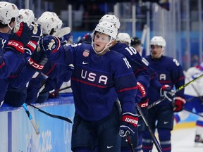 United States' Nick Abruzzese (16) is congratulated after scoring a goal against Slovakia during a game at the 2022 Winter Olympics. The 22-year-old forward will join the Maple Leafs in Boston, where Toronto takes on the Bruins on Tuesday.