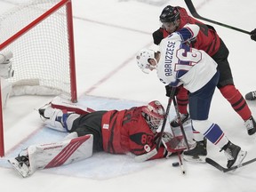 Team United States forward Nick Abruzzese (16) battles in front of the Canada net at the 2022 Winter Olympics  in Beijing. Abruzzese, who signed a two-year entry-level contract with the Maple Leafs on Saturday, took part in the morning skate at the TD Garden, on Tuesday.