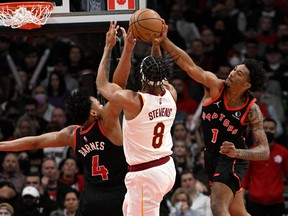 Raptors' Armoni Brooks (left) blocks a shot from Cleveland Cavaliers' Lamar Stevens in the second half at Scotiabank Arena on Thursday, March 24, 2022.