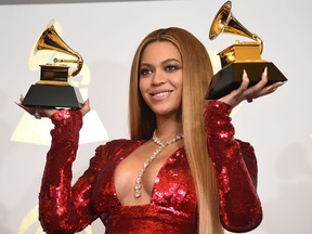 Beyonce poses with her Grammy trophies in the press room during the 59th Annual Grammy music Awards on February 12, 2017, in Los Angeles.