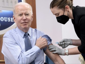 A member of the White House Medical Unit gives U.S. President Joe Biden his fourth dose of the Pfizer/BioNTech COVID-19 vaccine in the South Court Auditorium on March 30, 2022 in Washington, D.C.