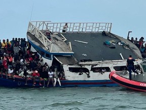 A boat packed with 356 Haitian migrants, which ran aground off Ocean Reef, is seen as the U.S. Coast Guard attend to it in the Florida Keys, Florida, March 6, 2022.