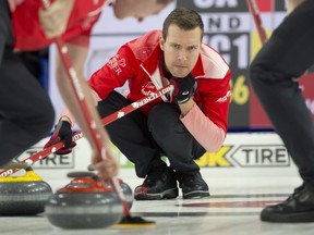 Team Canada skip Brendan Bottcher of Edmonton shouts to his front end second Brad Thiessen and lead Karrick Martin during their semifinal match against team Wild Card 1 skip Brad Gushue in Lethbridge, Alta., March 13, 2022.