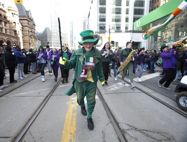 Paschal Brogan - the unofficial grand marshal of the parade - was back at the front of the line dancing along Queen St. With the Queen's University band behind him. After a two-year-hiatus because of COVID the Toronto St. Patrick's Day parade was back on the downtown streets of Toronto with over 4,000 participants - marching bands, dancers and floats. on Sunday March 20, 2022. Jack Boland/Toronto Sun/Postmedia Network