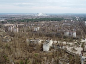 A New Safe Confinement (NSC) structure over the old sarcophagus covering the damaged fourth reactor at the Chernobyl Nuclear Power Plant is seen behind the abandoned town of Pripyat, Ukraine April 12, 2021.