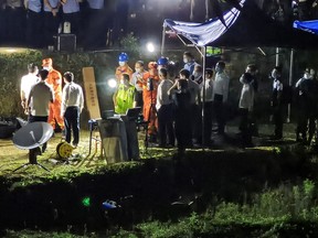This photo taken on March 21, 2022 shows rescuers working at the site of a plane crash in Tengxian county, Wuzhou city, in China's southern Guangxi region.