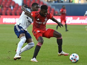 Toronto FC's Kemar Lawrence, right, keeps the ball aways from D.C. United's Nigel Robertha during first half MLS soccer action in Toronto on Sunday, Nov. 7, 2021.
