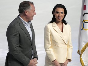 Anastasia Zadorina, chief designer and founder of the brand ZASPORT, right, and resident of the Russian Olympic Committee Stanislav Pozdnyakov smile after a presentation of the Olympic uniforms for Russian athletes in Moscow, Russia, Friday, Dec. 10, 2021.
