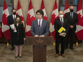 Public Safety Minister Marco Mendicino, Deputy Prime Minister and Finance Minister Chrystia Freeland, Justice Minister and Attorney General of Canada David Lametti and President of the Queen’s Privy Council for Canada and Emergency Preparedness Minister Bill Blair stand behind Canadian Prime Minister Justin Trudeau announces the Emergencies Act will be invoked to deal with protests, Monday, February 14, 2022 in Ottawa.