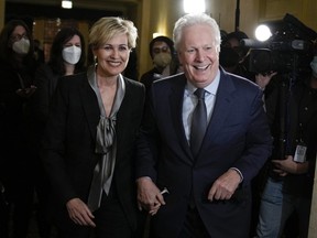 Jean Charest arrives with his wife Michele Dionne for an event with potential caucus supporters as he considers a run for the leadership of the Conservative Party of Canada, in Ottawa, on Wednesday, March 2, 2022.