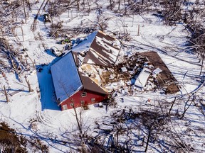 Snow covers a tornado-damaged home Monday, March 7, 2022, south of Winterset, Iowa. Several people were killed at the home when the tornado struck over the weekend.