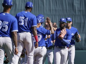 Toronto Blue Jays players celebrate their 9-5 win over the Baltimore Orioles during a spring training baseball game at the Ed Smith Stadium Friday March 18, 2022, in Sarasota, Fla. The Blue Jays won the game 9-5.