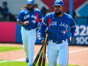 Blue Jays' Teoscar Hernandez, right, and Vladimir Guerrero Jr. jog to the dugout before the start of a spring training baseball game at TD Ballpark, in Dunedin, Fla., Sunday, March 27, 2022.