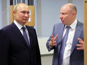Vladimir Potanin, the billionaire owner of a nickel giant, right, gestures while speaking to Russian President Vladimir Putin in Sochi, Russia on Tuesday, Dec. 3, 2019.