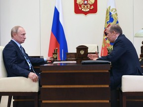 Russian President Vladimir Putin, left, listens to Federal Security Service (FSB) director Alexander Bortnikov during their meeting at the Novo-Ogaryovo residence outside Moscow, Russia, Tuesday, June 16, 2020.