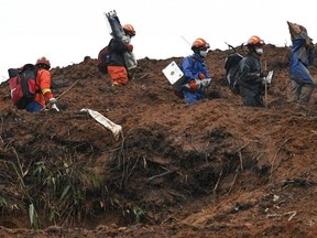 Rescue workers comb through the site on March 24, 2022 where China Eastern flight MU5375 crashed on March 21, near Wuzhou in southwestern Chinas Guangxi province.