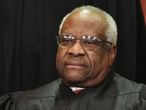 In this file photo taken on Nov. 30, 2018 Associate Justice Clarence Thomas poses for the official group photo at the U.S. Supreme Court in Washington, D.C.