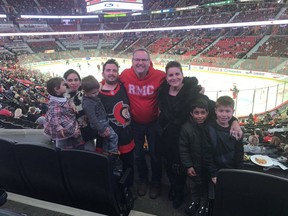 Ahmad, his wife, Tamana, children, Sajad, 10, Mohammad, 4, and Ossna, 2, and retired Lt. Col. Tony White and his wife Simonne take in a recent Ottawa Senators game.