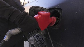 Kathy Glazer-Chow pumps premium gas into her Toyota and at an Esso station at Danforth and Victoria Park. Ave. on Thursday, March 3, 2022. JACK BOLAND/TORONTO SUN
