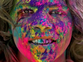 The face of a boy is seen daubed in colours as he takes part in Holi celebrations in Ahmedabad, India, March 18, 2022.