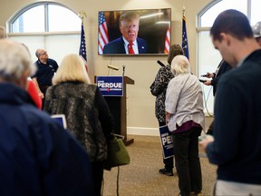 Former U.S. President Donald Trump appears in a video endorsing former Republican U.S. Senator David Perdue, who is primarying incumbent Brian Kemp for Georgia governor, at a campaign event in Covington, Ga., Feb. 2, 2022.