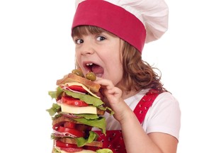 hungry little girl cook eat large sandwich