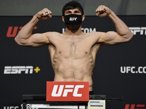 In this handout image provided by UFC, Magomed Ankalaev of Russia poses on the scale during the UFC weigh-in at UFC APEX on Feb. 26, 2021 in Las Vegas, Nevada.