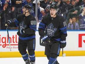 Maple Leafs' Mitch Marner (right) celebrates a goal against the New Jersey Devils at Scotiabank Arena on Wednesday, March 23, 2022 in Toronto.