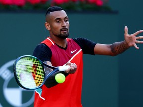 Nick Kyrgios of Australia plays a forehand against Rafael Nadal of Spain in their quarterfinal match on Day 11 of the BNP Paribas Open at the Indian Wells Tennis Garden on March 17, 2022 in Indian Wells, California. (Photo by Clive Brunskill/Getty Images)