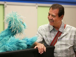 Sesame Street's Luis (Emilio Delgado), right, and Muppet Rosita chat during the introduction of the "You Can Ask!" program June 25, 2003 in New York City.
