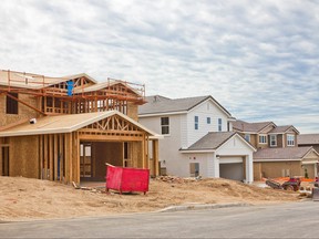 A new home being built next to pre-existing homes.