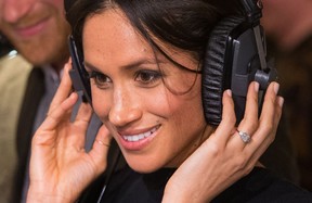 PODCASTING PLATITUDES: Britain’s Prince Harry’s fiancée US actress Meghan Markle listens to a broadcast through headphones during a visit to Reprezent 107.3FM community radio station in Brixton, south west London on January 9, 2018. (DOMINIC LIPINSKI/AFP via Getty Images)
