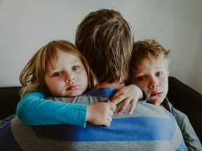 sad kids hugging father, family in sorrow, loss and pain concept
