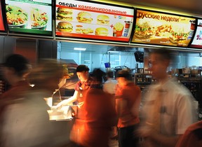 Employees serve clients in a McDonald's restaurant on Pushkin square in Moscow on February 1, 2010. ALEXANDER NEMENOV/AFP via Getty Images)